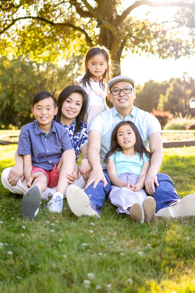 Family of five sits under tree at kohl mansion burlingame during golden hour