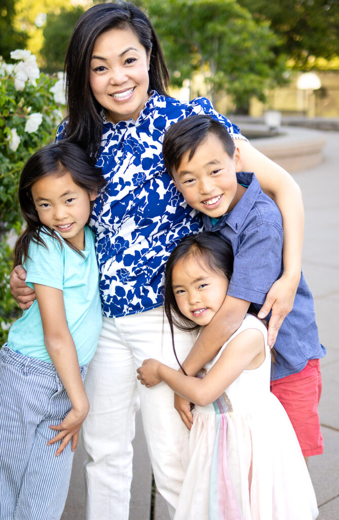 Warm close-up of mom and kids smiling and snuggling