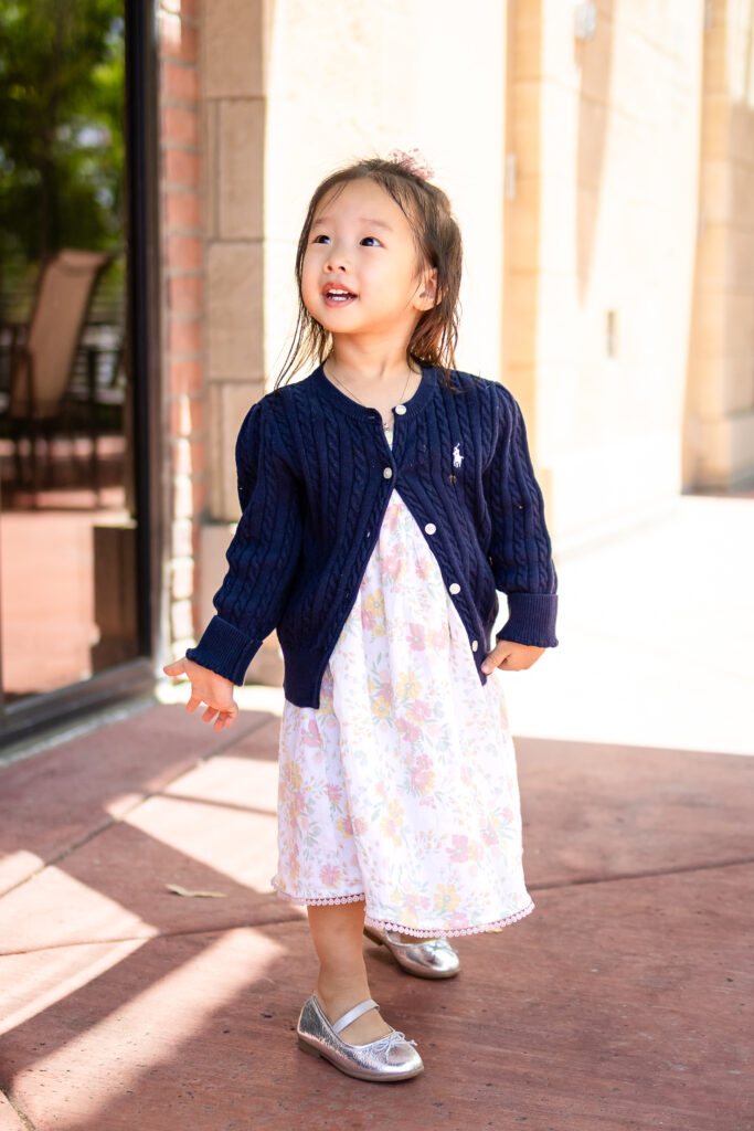Joyful toddler exploring outdoors during a relaxed lifestyle family photoshoot.