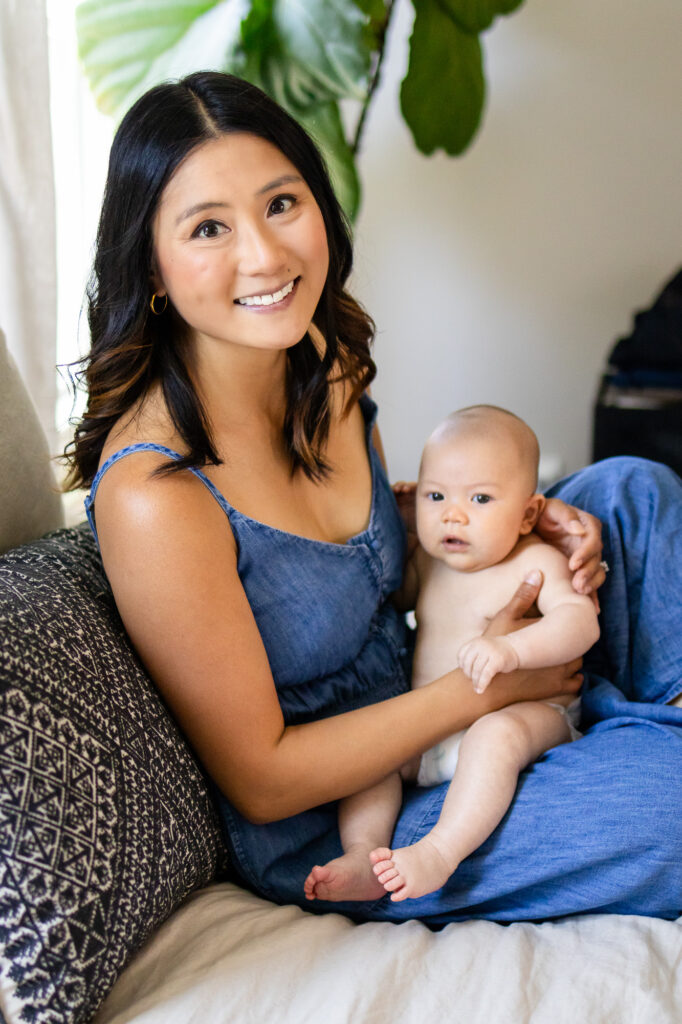 A mother holding her baby close, both looking content and connected
