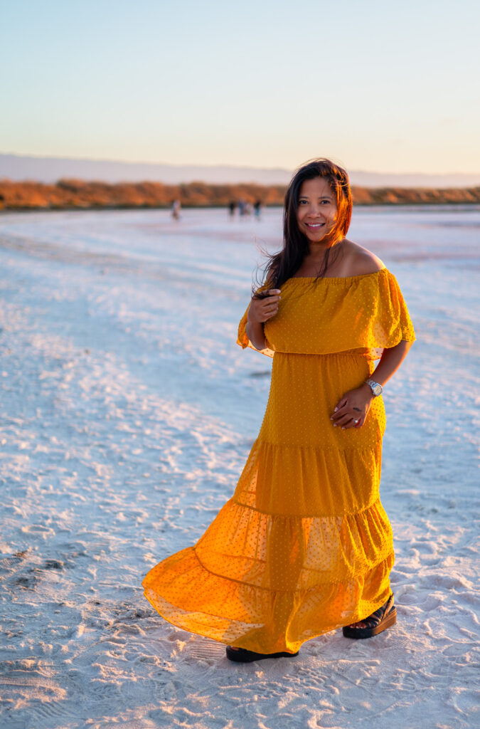 Mom stands smiling in a flowing yellow dress during golden hour at Alviso Marina County Park – Ellobelle Photography