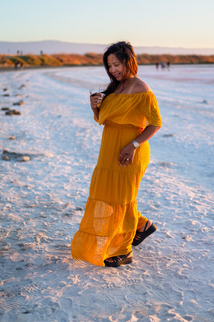 Woman looks down softly while walking barefoot on the salt flats at Alviso Marina County Park – Ellobelle Photography