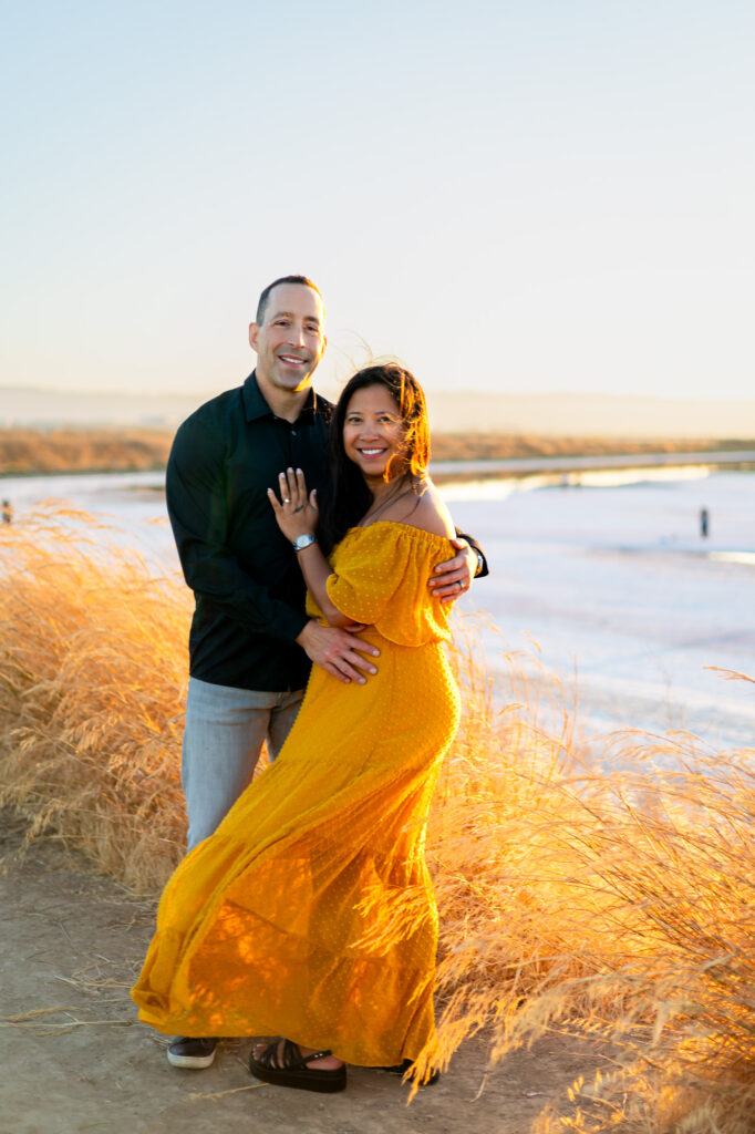 Couple embracing in sunshine at Alviso Marina County Park – Ellobelle Photography