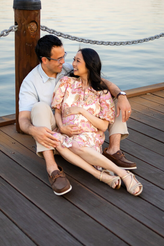 Maternity Photography Poses - ellobelle photography: couple cuddling on dock, gazing at each other and cradling baby bump