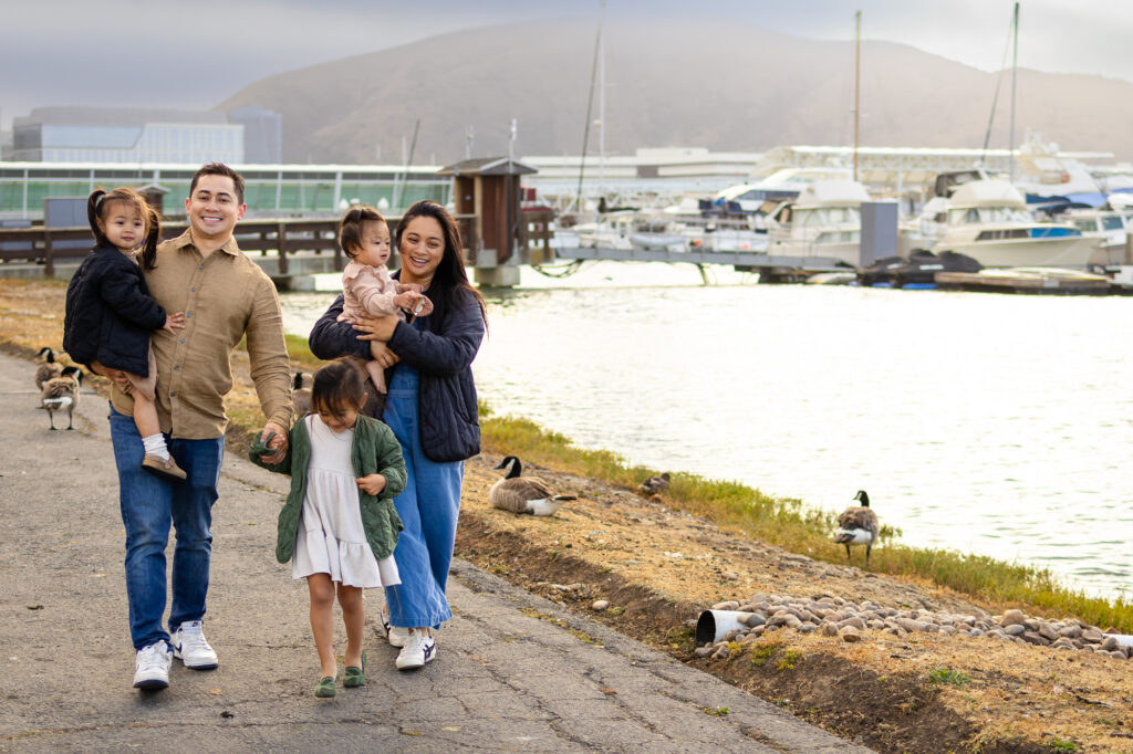 Family walking hand-in-hand along the shoreline at in South San Francisco