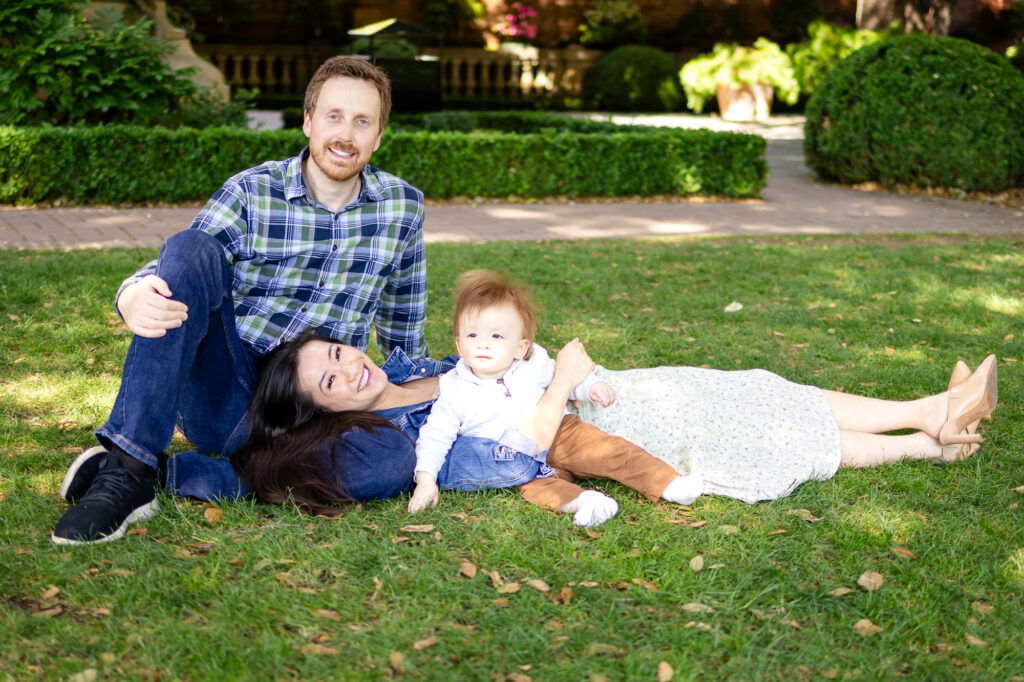 What to Wear for Family Photoshoot a relaxed family lounging on grass during a playful moment.