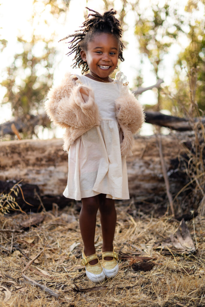 Girl smiling in a cream dress and jacket – Ellobelle Photography