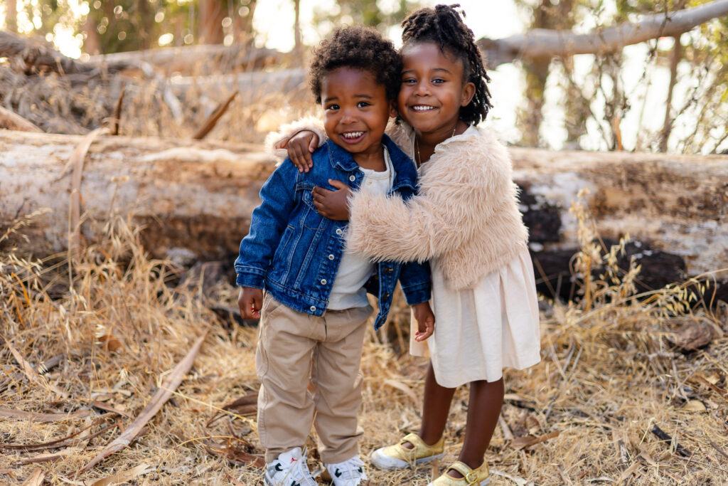 Siblings laughing together outdoors at Coyote Point – Ellobelle Photography