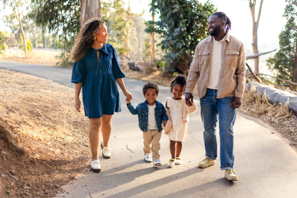Family walking hand in hand along the path at Coyote Point – Ellobelle Photography
