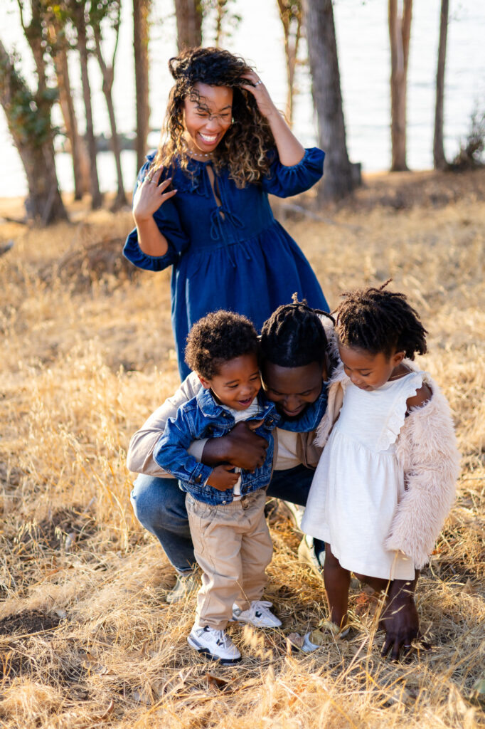 Parents and kids sharing playful moment in the field at Coyote Point – Ellobelle Photography