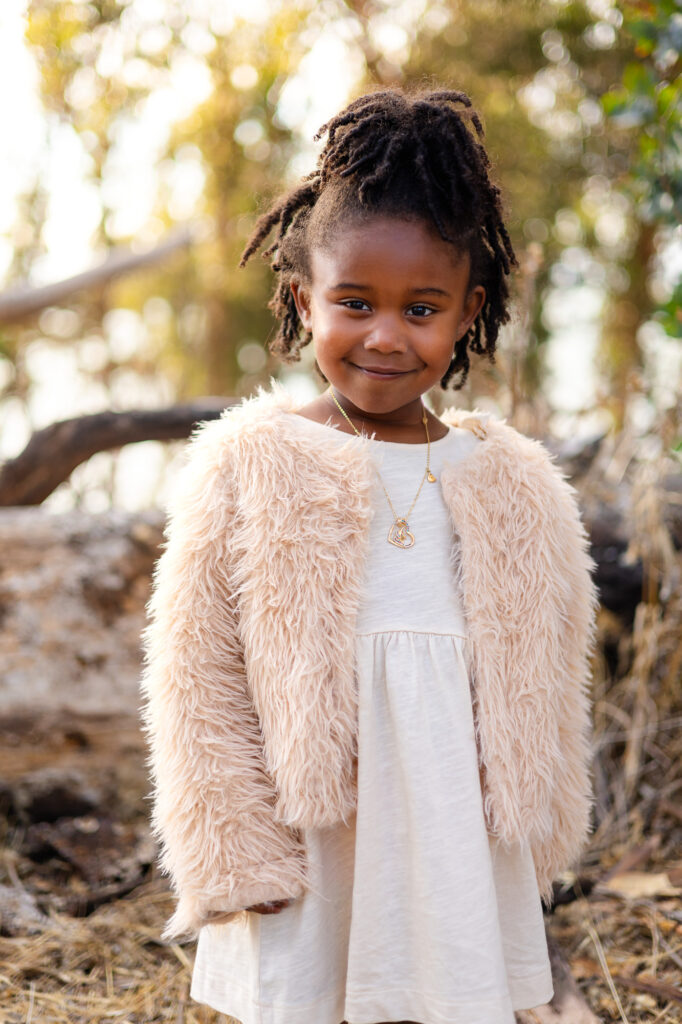 Young girl in white dress with fur jacket at Coyote Point – Ellobelle Photography