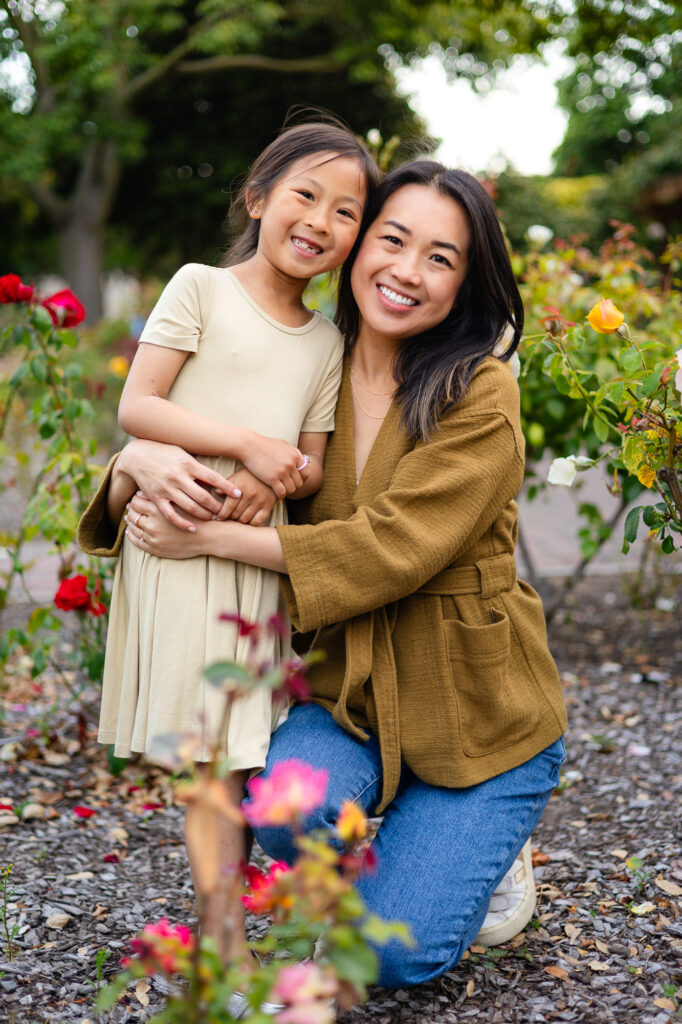 Sweet portrait of mom and daughter embracing among roses during Mini Sessions Photography - Ellobelle Photography.