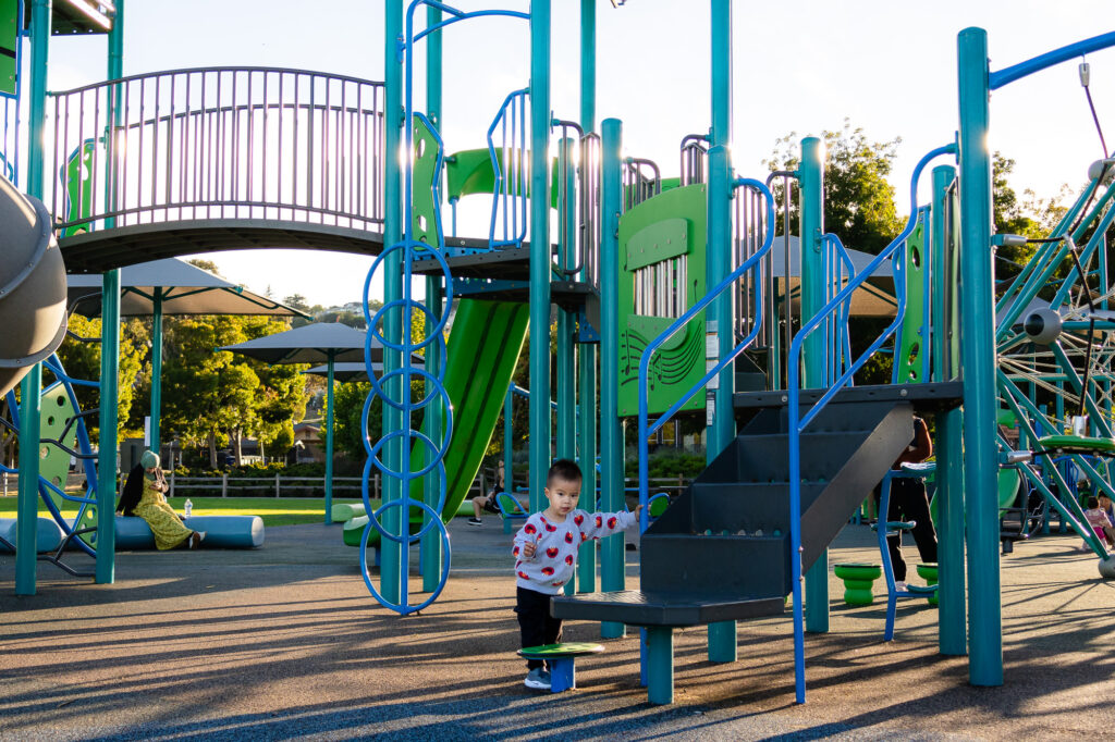 Toddler exploring the Central Park Millbrae playground structure – Ellobelle Photography