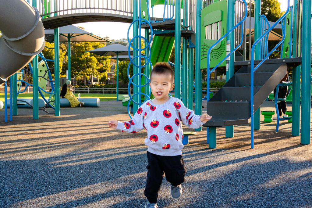 Happy child running across the playground at Millbrae Central Park – Ellobelle Photography