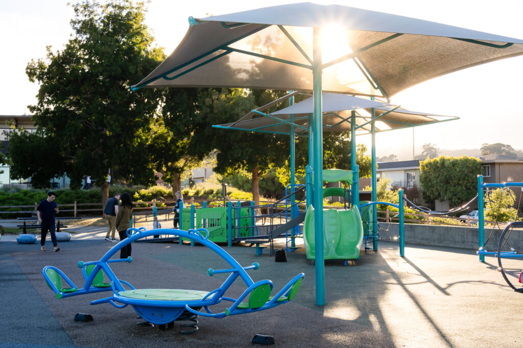Shaded play zone with slides and roundabout at Central Park Millbrae – Ellobelle Photography