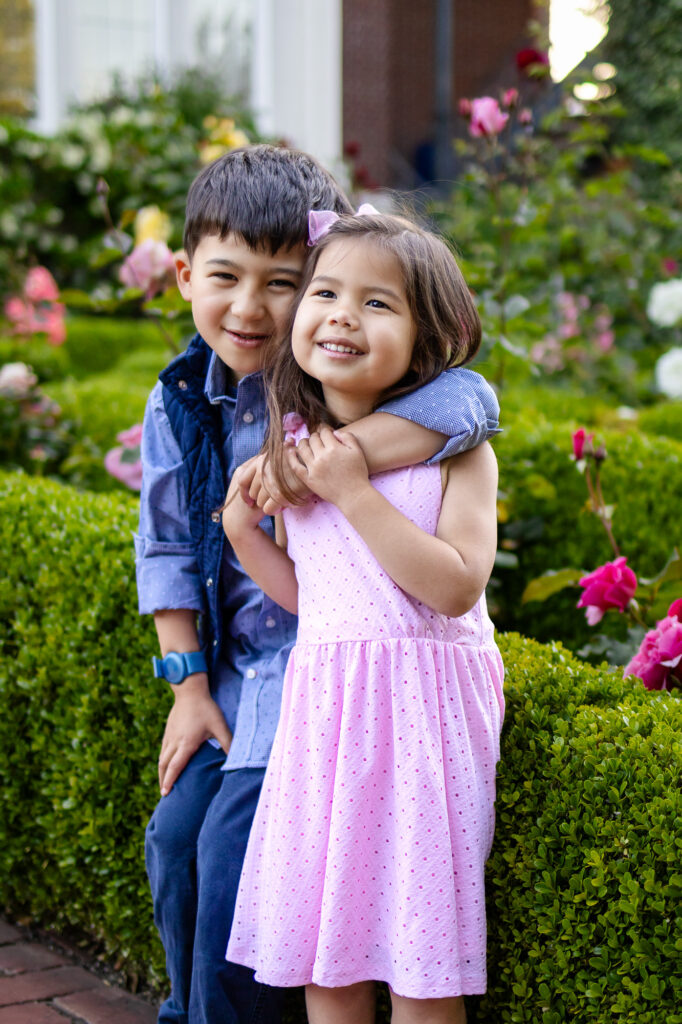 Young siblings smiling together in the gardens of Kolh Mansion – Ellobelle Photography