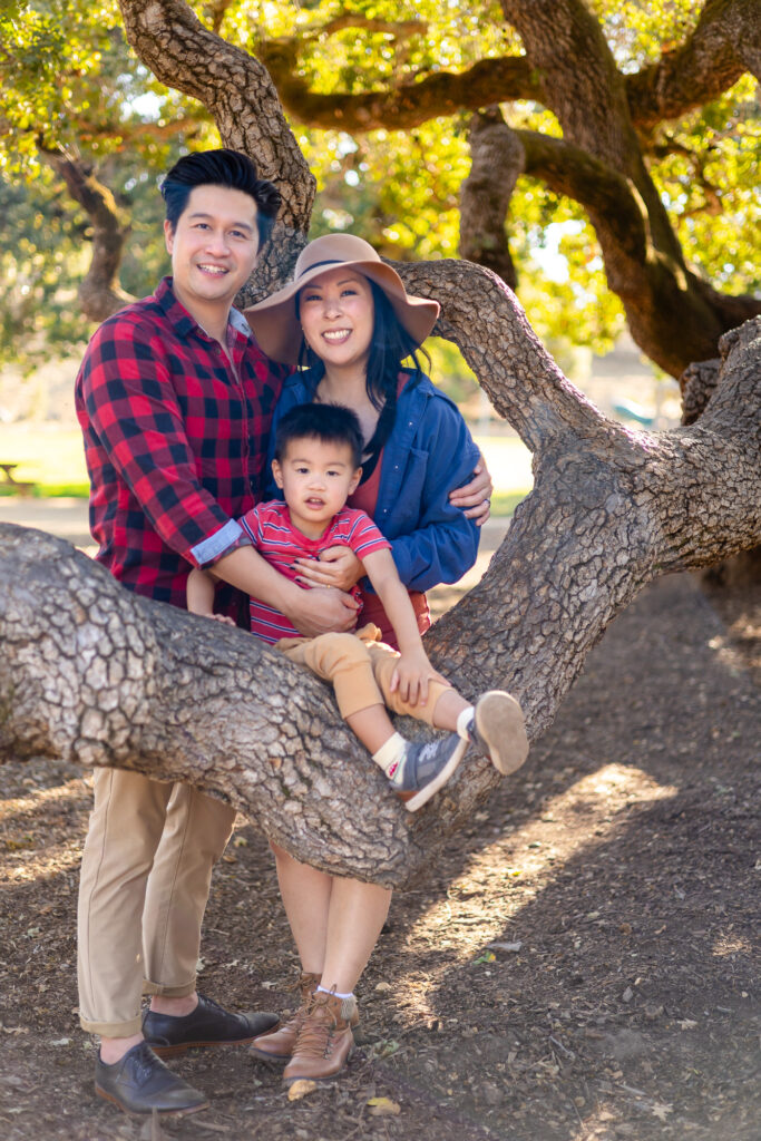 Family gathered together on oak tree branches at Laurelwood