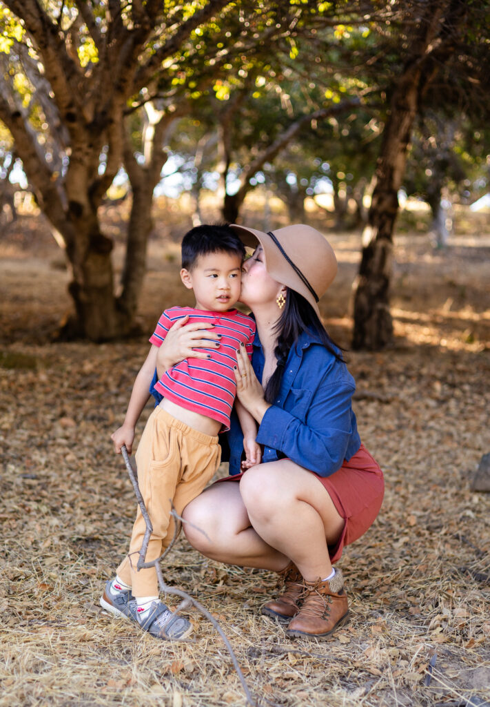 Mom kissing her son’s cheek during a San Mateo County park family photoshoot
