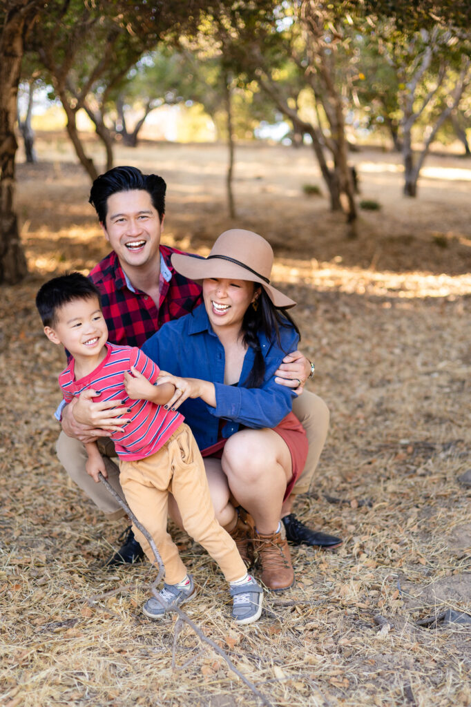 Parents hugging their son while laughing at sunset spots along the Laurelwood trails