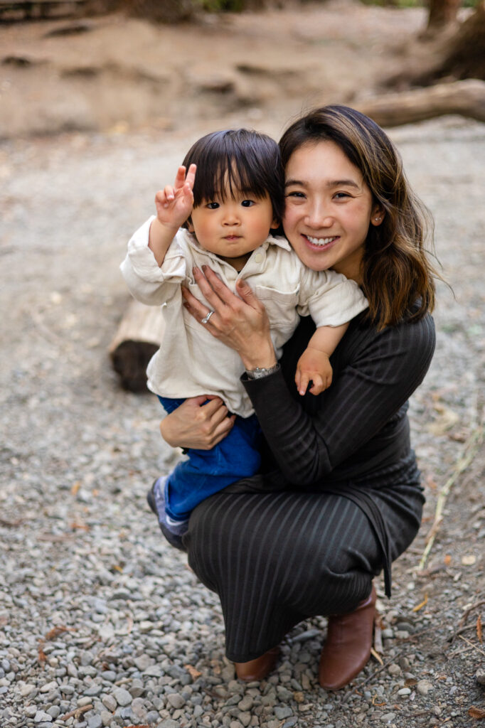 Mom kneeling with toddler smiling at camera at Redwood Grove Nature Preserve – Ellobelle Photography