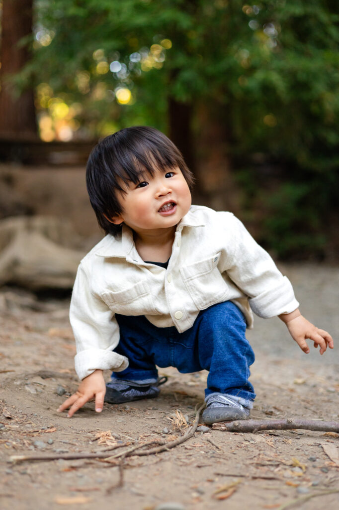 Toddler crouching and smiling at Redwood Grove Nature Preserve photos – Ellobelle Photography