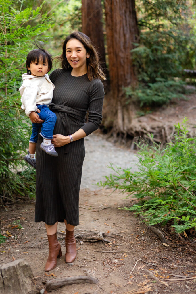 Mom holding toddler in greenery at Redwood Grove Los Altos – Ellobelle Photography