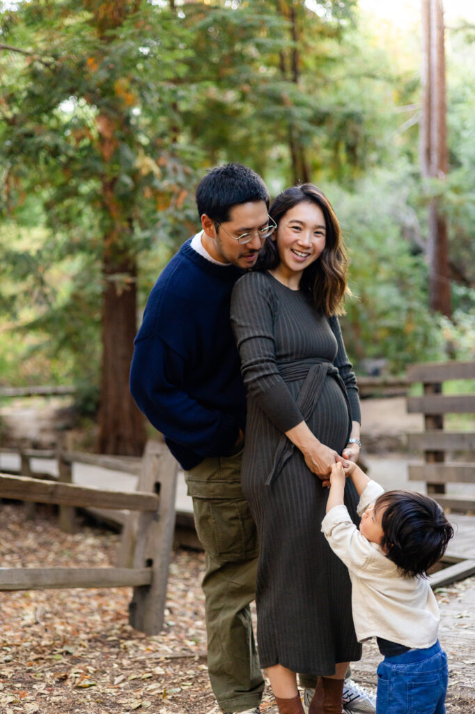 Joyful maternity moment with husband and child at Redwood Grove Nature Preserve Los Altos Redwood Grove Nature Preserve photos Ellobelle Photography