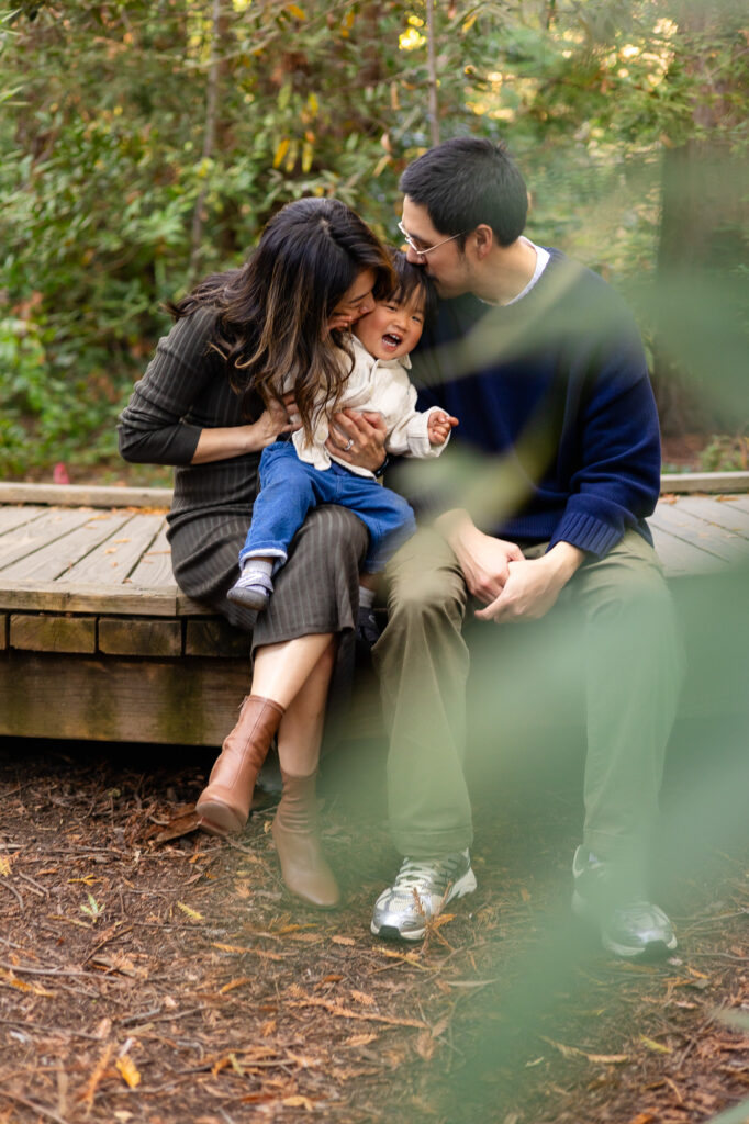 Family cuddles and laughter on wooden deck at Redwood Grove Nature Preserve – Ellobelle Photography