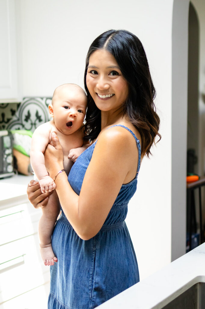 Smiling mom holding yawning baby – Ellobelle Photography San Francisco Newborn Photography