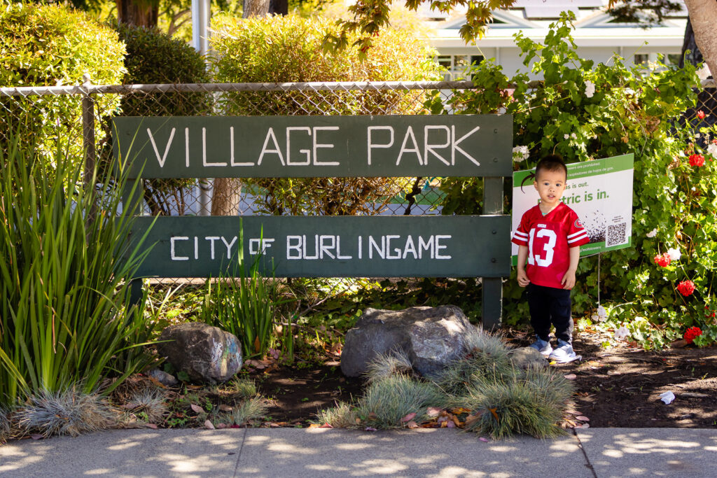 Toddler standing by Village Park Burlingame sign – Ellobelle Photography