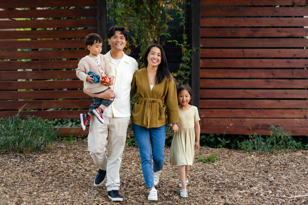 Family walking hand in hand near garden path at Washington Park Burlingame – Ellobelle Photography