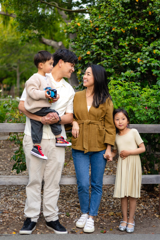 Family smiling together by greenery at Washington Park – Ellobelle Photography