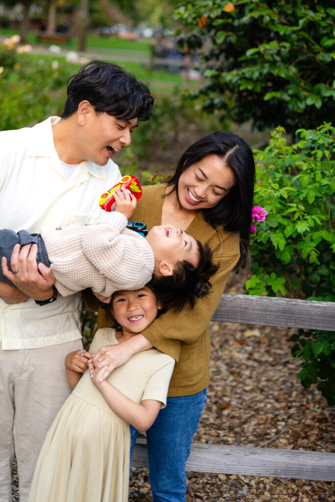 Parents laughing with kids during playful photo moment at Burlingame – Ellobelle Photography
