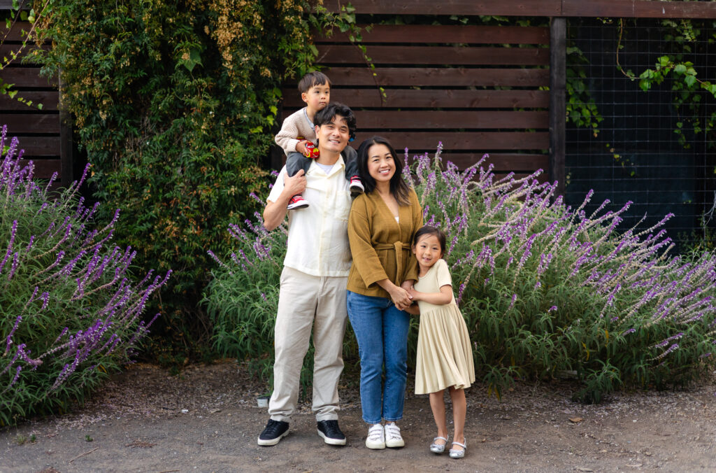 Family standing by purple flowers at Washington Park – Ellobelle Photography