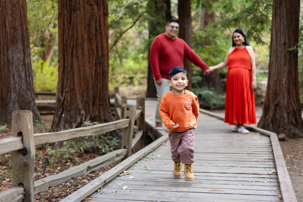 Toddler running on a wooden path in redwoods during Bay Area maternity shoot – Ellobelle Photography