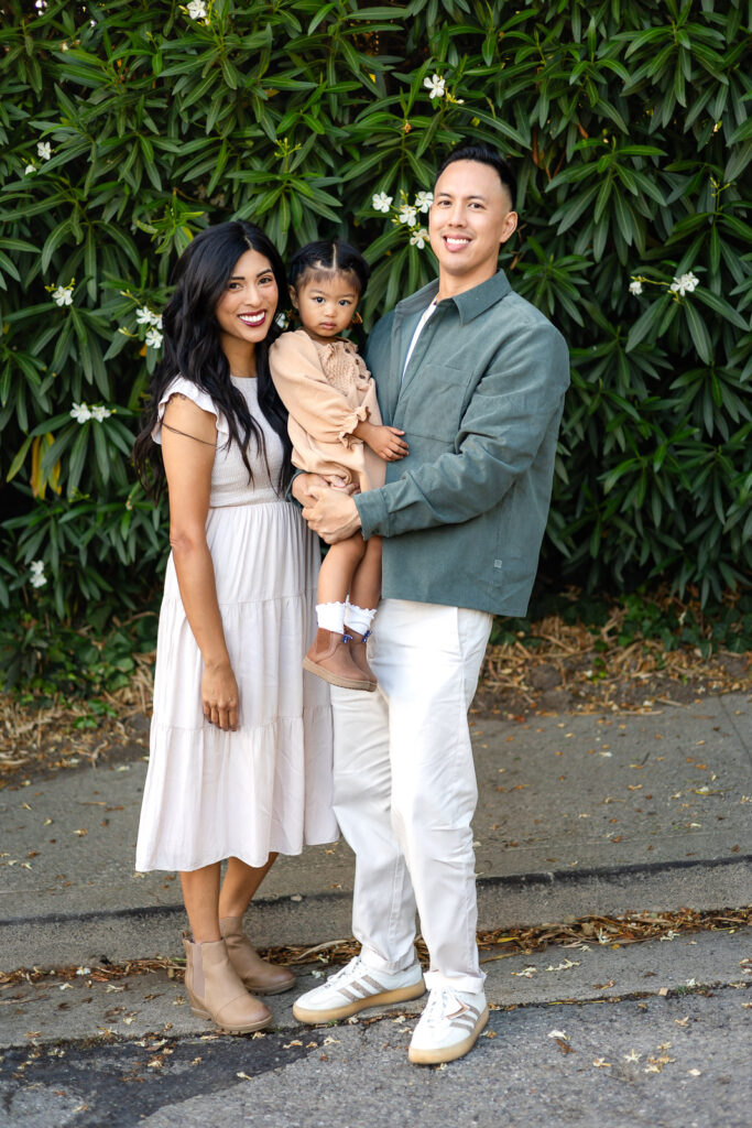Smiling family posing together during holiday photo sessions outdoors – Ellobelle Photography