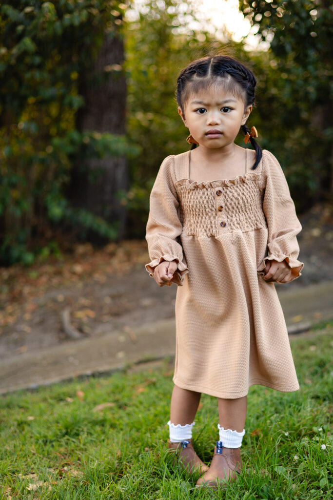 Young girl standing in nature during holiday photo sessions – Ellobelle Photography