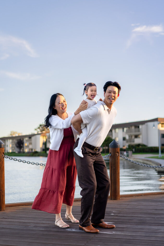Family playing on the dock at Leo Ryan Park in the evening
