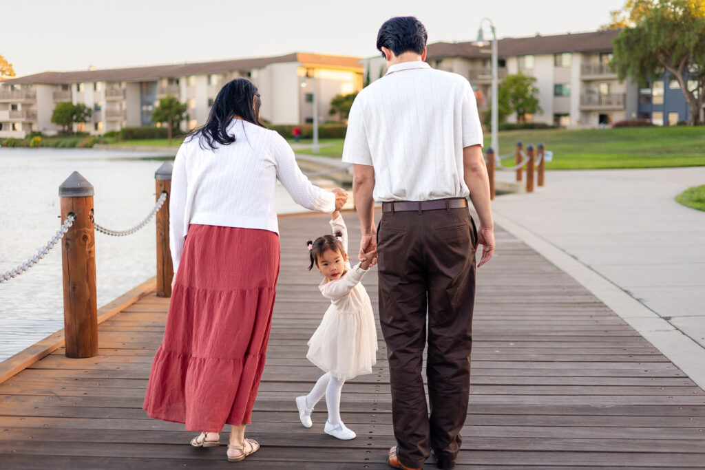 Parents swinging daughter by the arms while walking