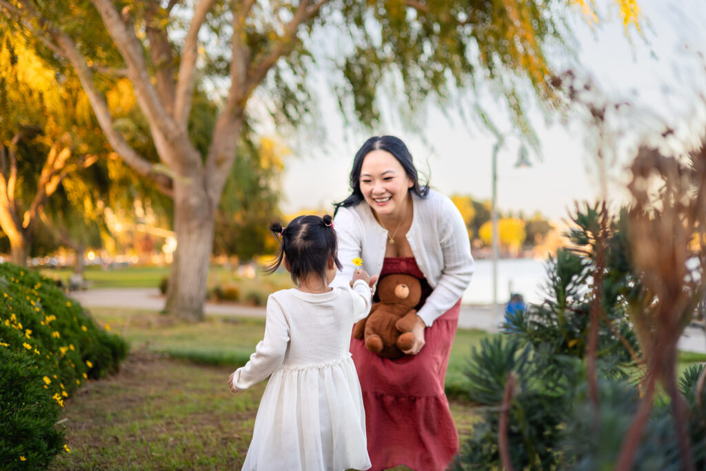 Daughter giving mom a flower during playtime at Leo Ryan waterfront park