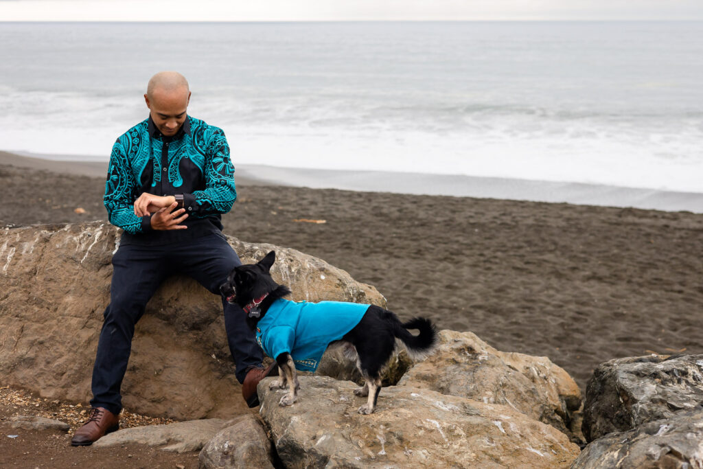 Man checking his watch while his dog watches him during a relaxed natural pet and family portraits