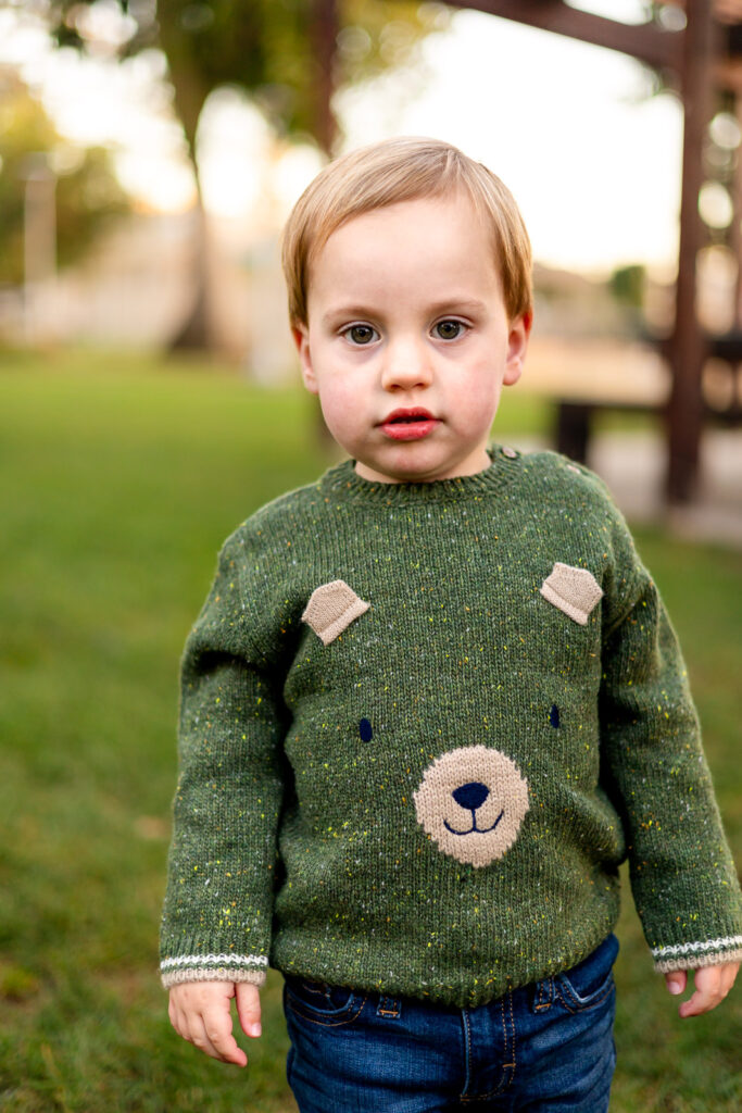 Toddler boy standing on grass during outdoor school portraits photographed by Bay Area Preschool Photographer in San Mateo – Ellobelle Photography