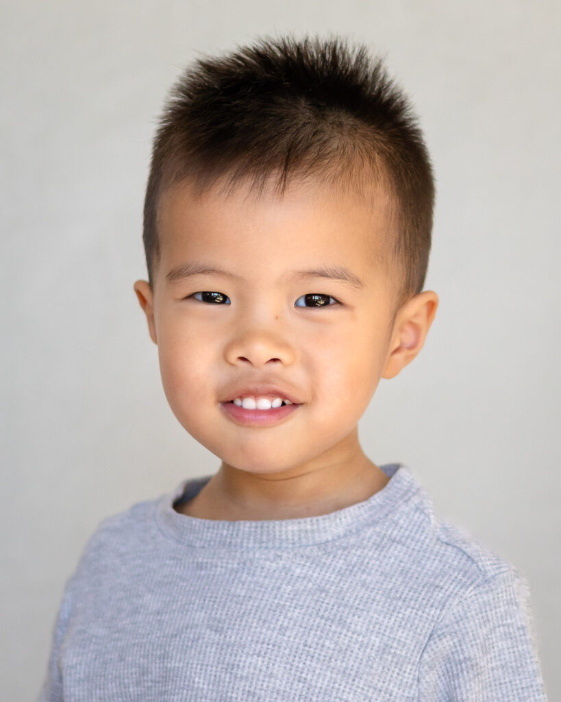 Natural light preschool portrait on soft outdoor backdrop 