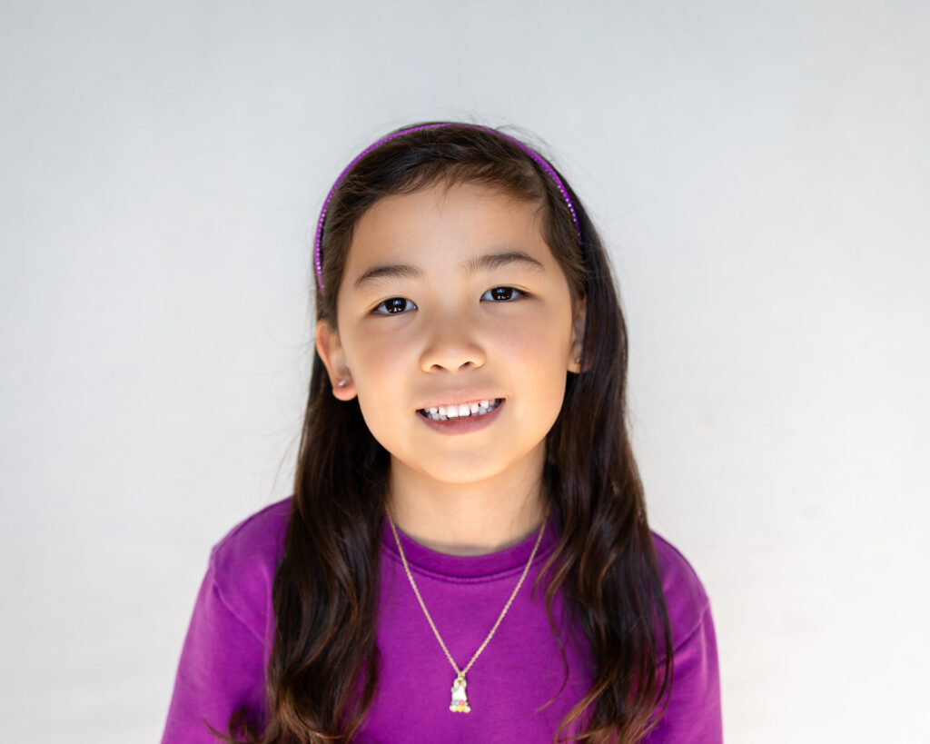 Student portrait on a bright outdoor backdrop by preschool Photographer