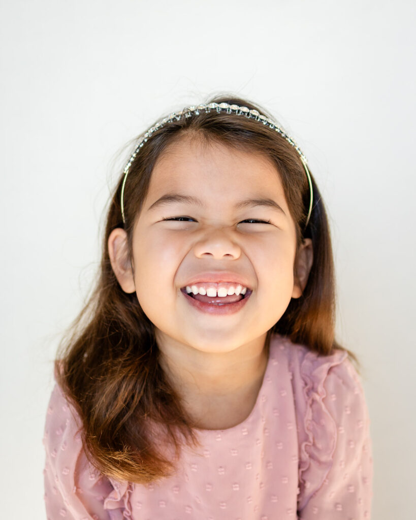 Joyful natural light Bay Area photography for schools on soft backdrop in San Francisco Peninsula