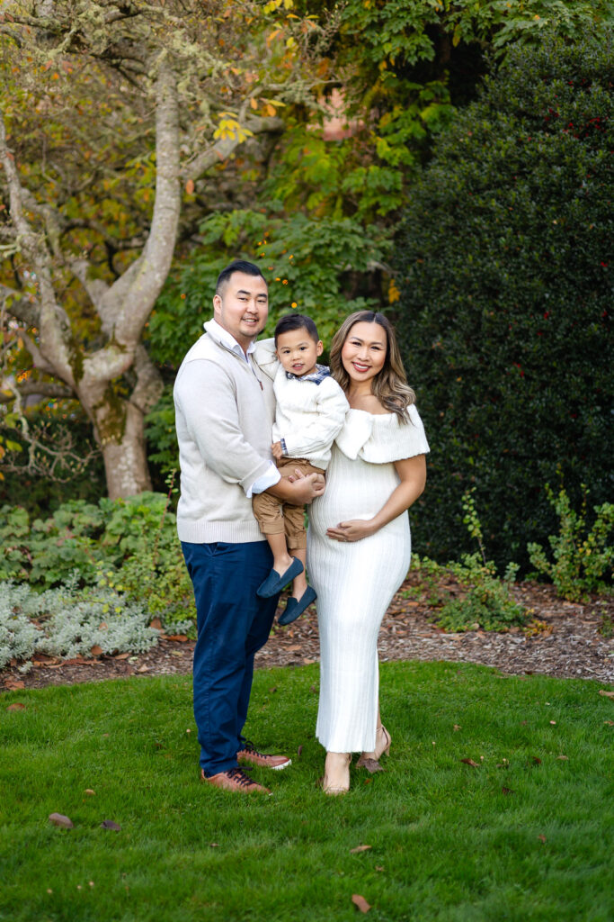 Family standing together on the lawn at Filoli surrounded by fall leaves and greenery