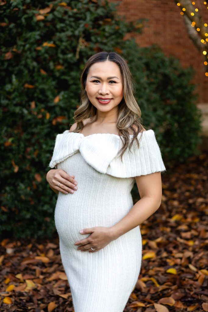 Maternity portrait in front of greenery and fall leaves during Filoli Christmas Photos