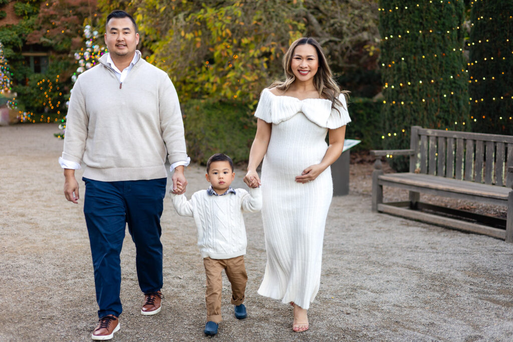 Family walking toward the camera on the Filoli garden path during Christmas portraits at the Filoli estate