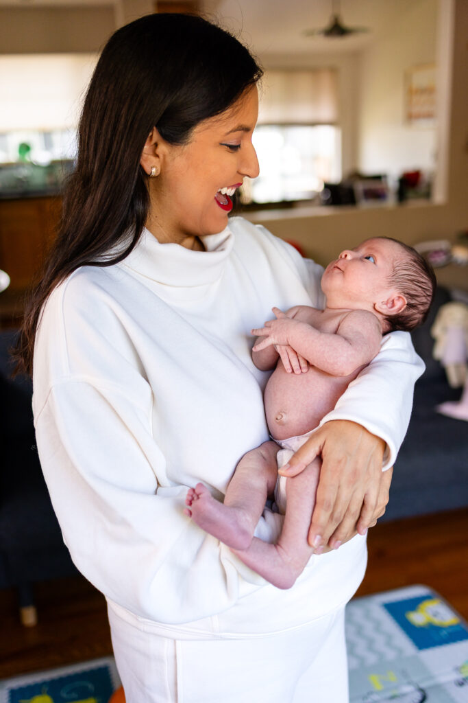 Mother holding her newborn during a San Mateo lifestyle session inspired by Bay Area prenatal support