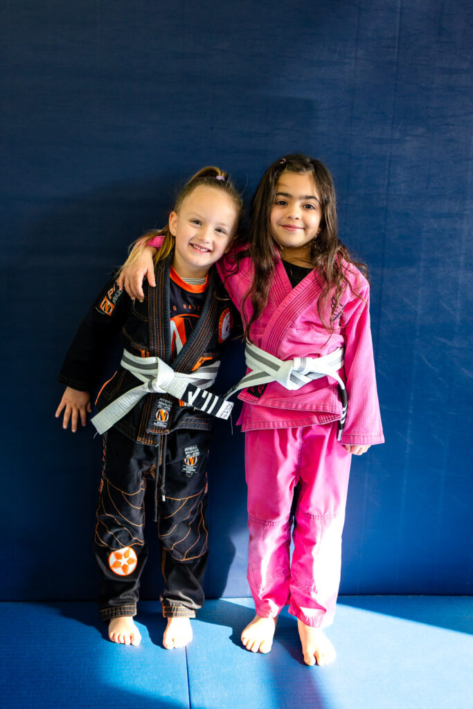 Two young girls in Jiu Jitsu gis posing